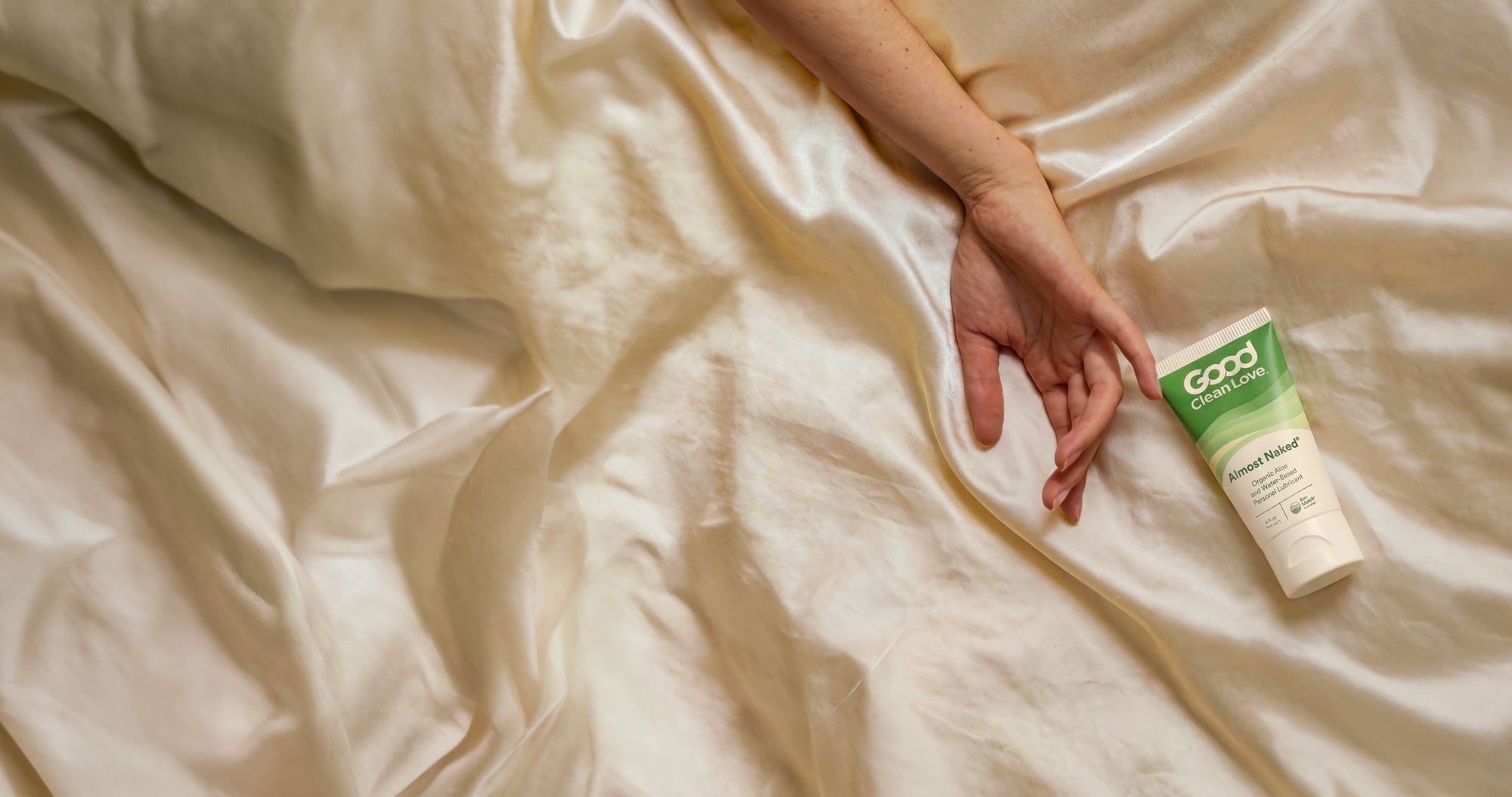 Hand in sheets with almost naked.